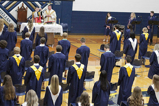 Father Joshua Duncan, a chaplain at Helias Catholic, elevates the Most Precious Blood during the Baccalaureate Mass in the Rackers Fieldhouse.